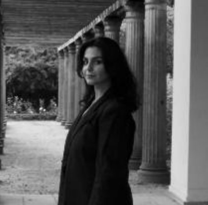 Black and white portrait of Bresa Ayub among columns